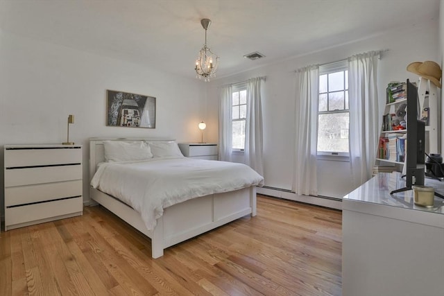 bedroom featuring a notable chandelier, visible vents, light wood finished floors, and a baseboard radiator