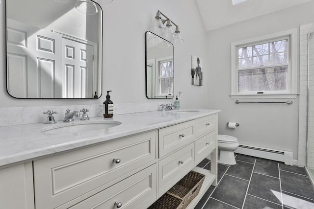 bathroom with a sink, baseboard heating, toilet, and lofted ceiling