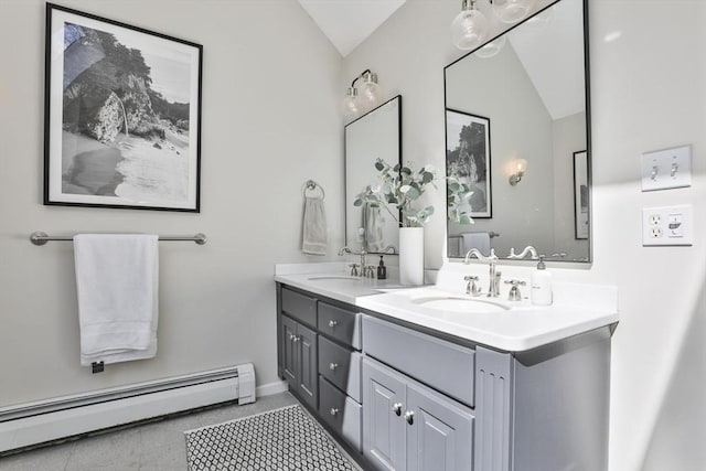 bathroom with a sink, a baseboard radiator, double vanity, and lofted ceiling
