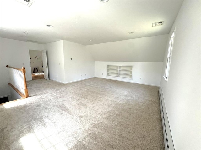 bonus room featuring built in features, a baseboard radiator, baseboards, and light colored carpet