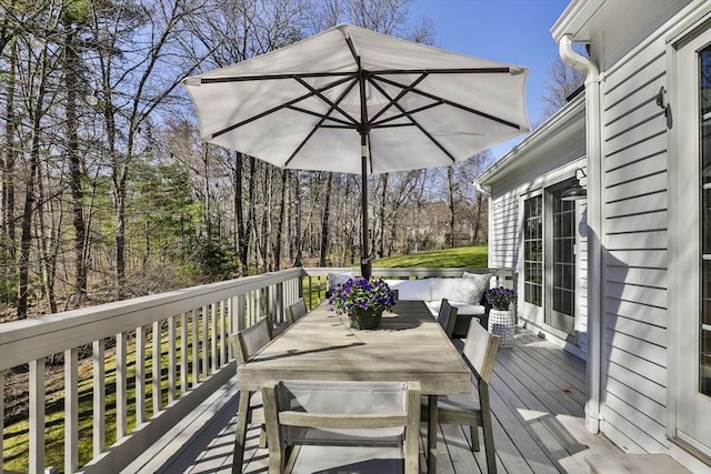 wooden terrace with outdoor dining space