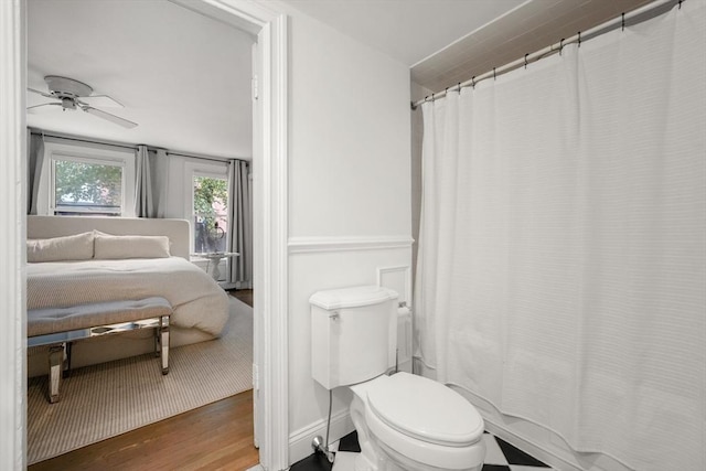bathroom with wood finished floors, a ceiling fan, and toilet
