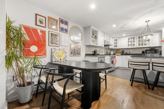 dining space with recessed lighting and dark wood finished floors