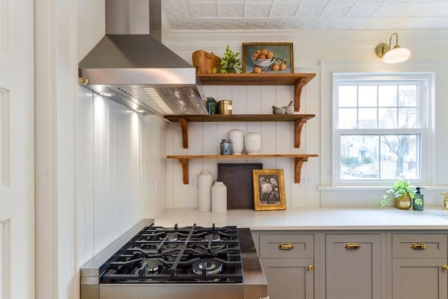 kitchen featuring ventilation hood, light countertops, stovetop, gray cabinets, and open shelves