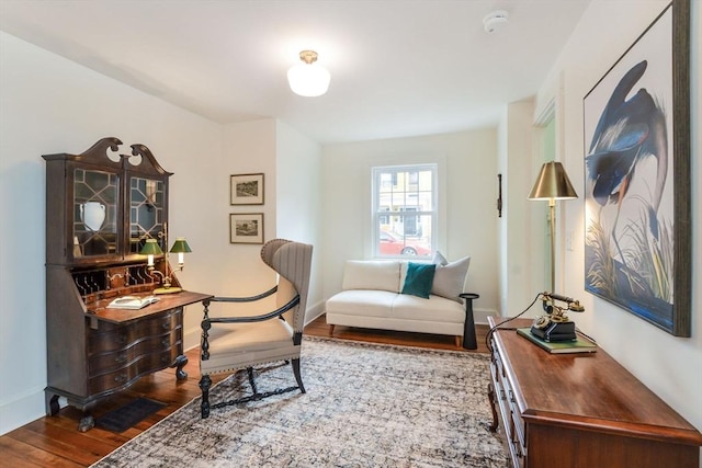 sitting room with wood finished floors and baseboards