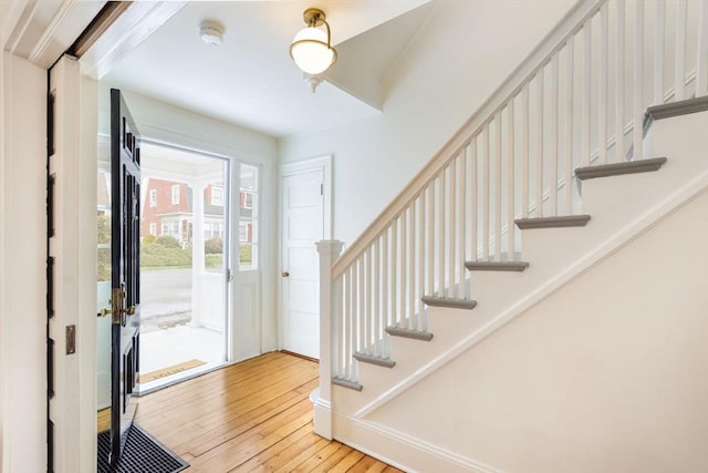 entrance foyer with visible vents, stairs, baseboards, and hardwood / wood-style floors