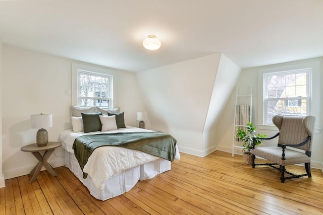 bedroom featuring baseboards and light wood finished floors