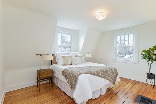 bedroom featuring light wood-style flooring and baseboards