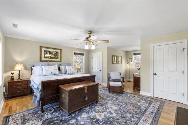 bedroom featuring light wood-style floors, baseboards, and visible vents