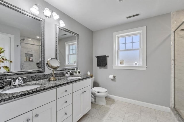 full bath featuring visible vents, a sink, a stall shower, and toilet