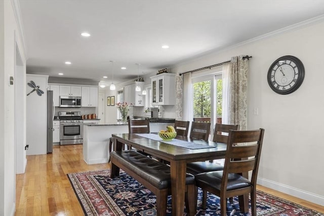 dining room with recessed lighting, ornamental molding, baseboards, and light wood-type flooring