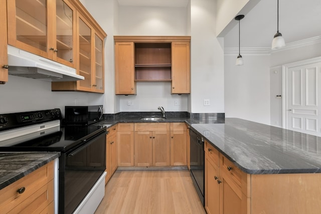 kitchen with dark stone countertops, pendant lighting, light wood-type flooring, black appliances, and ornamental molding