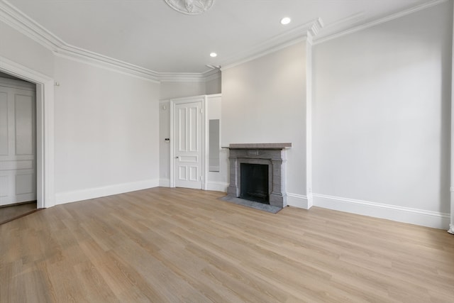 unfurnished living room featuring crown molding, light hardwood / wood-style floors, and a tile fireplace