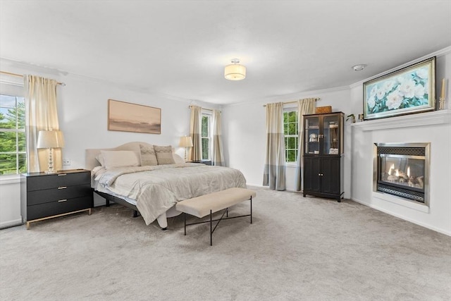69 Kame St, Brockton, MA 02302 - bedroom with light colored carpet, a glass covered fireplace, and ornamental molding