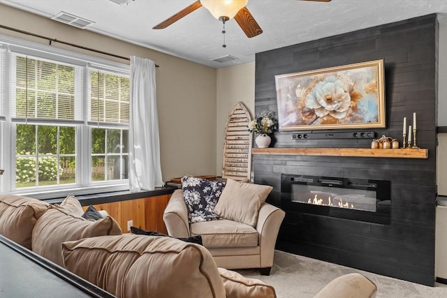 69 Kame St, Brockton, MA 02302 - carpeted living room with ceiling fan and a large fireplace