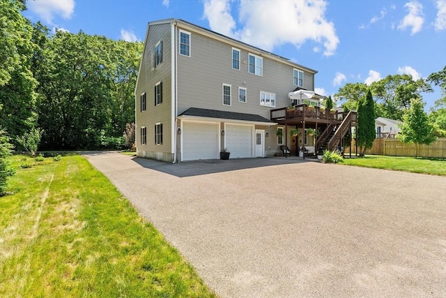 69 Kame St, Brockton, MA 02302 - view of front of house featuring stairs, a deck, driveway, and a garage