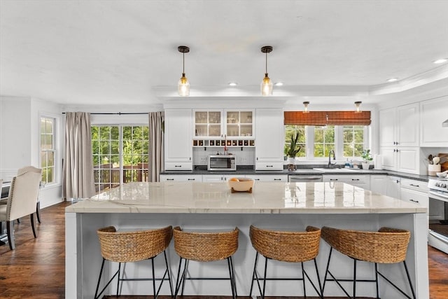 69 Kame St, Brockton, MA 02302 - kitchen featuring plenty of natural light, stainless steel appliances, white cabinetry, decorative backsplash, and recessed lighting
