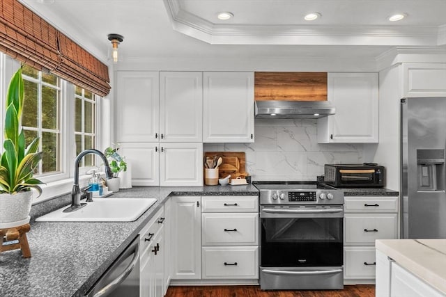 69 Kame St, Brockton, MA 02302 - kitchen featuring stainless steel appliances, extractor fan, crown molding, backsplash, and white cabinets