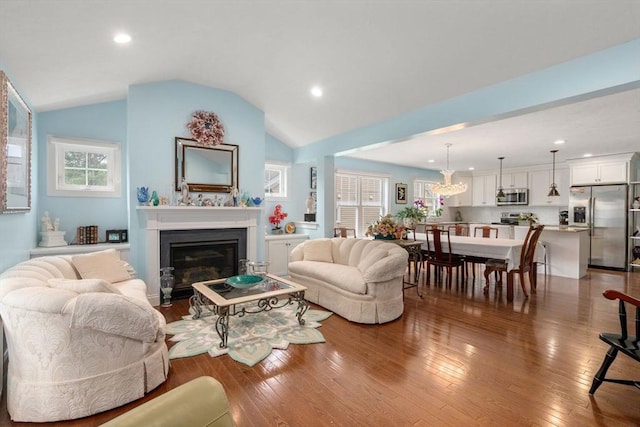 16 Winterberry Way, Plymouth, MA 02360 - living room with a glass covered fireplace, a wealth of natural light, lofted ceiling, and dark wood finished floors