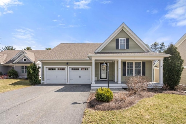 16 Winterberry Way, Plymouth, MA 02360 - view of front facade with aphalt driveway, roof with shingles, covered porch, a front yard, and a garage