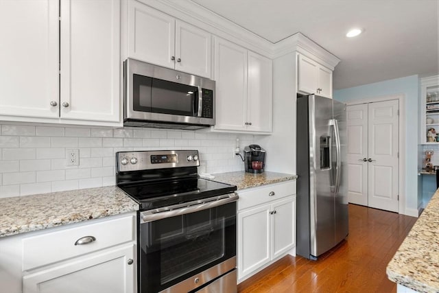 16 Winterberry Way, Plymouth, MA 02360 - kitchen featuring light wood finished floors, light stone countertops, backsplash, white cabinets, and appliances with stainless steel finishes