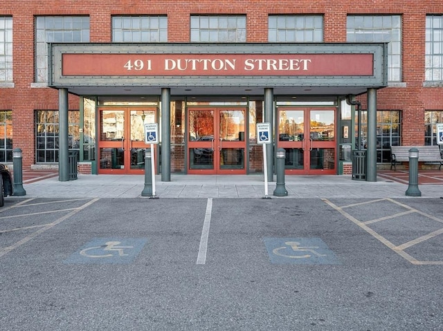 view of building exterior featuring uncovered parking
