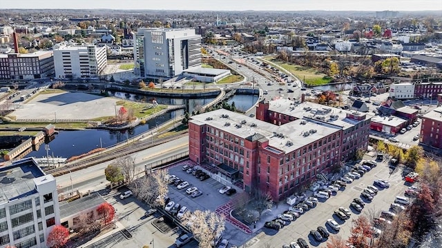birds eye view of property featuring a water view and a view of city