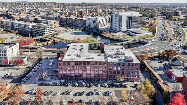 birds eye view of property featuring a water view and a city view