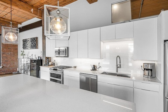 kitchen with a sink, light countertops, stainless steel appliances, wooden ceiling, and beamed ceiling