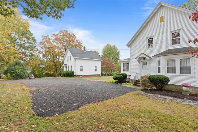 view of property exterior with a yard