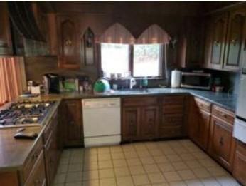 kitchen with appliances with stainless steel finishes and light tile patterned floors