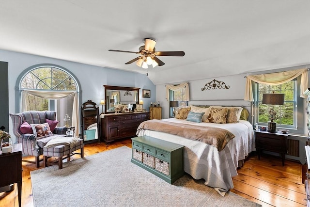 bedroom with multiple windows, light wood-style floors, and a ceiling fan