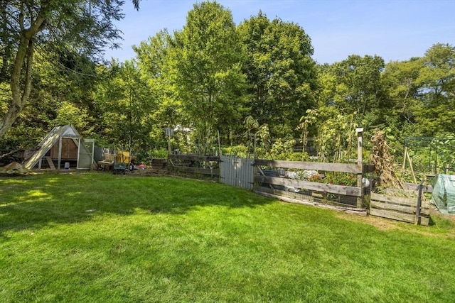 view of yard with a garden and a gate