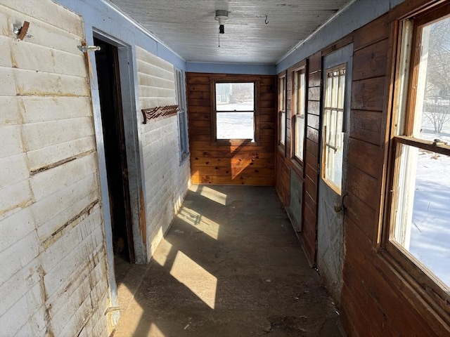 unfurnished sunroom featuring wood ceiling