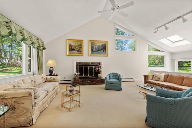 100 Parmenter Rd, Framingham, MA 01701 - carpeted living room with a baseboard radiator, lofted ceiling, track lighting, a fireplace, and a skylight