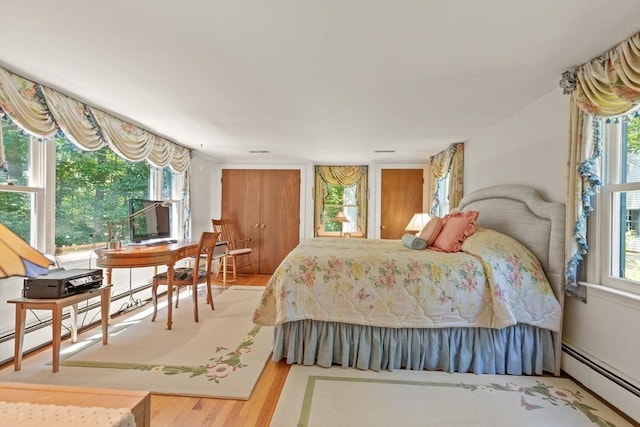 100 Parmenter Rd, Framingham, MA 01701 - bedroom with a baseboard radiator and wood finished floors