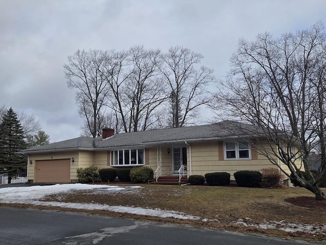 single story home with a garage, driveway, and a chimney