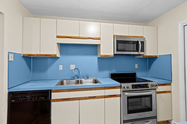 kitchen with sink, white cabinetry, and stainless steel appliances