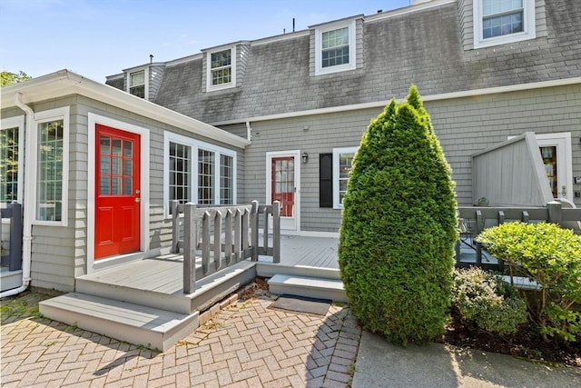 back of property with a wooden deck