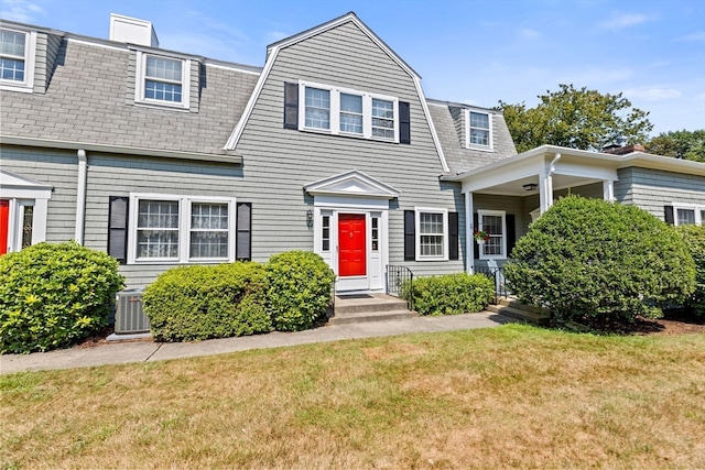 townhome / multi-family property with central AC and a front lawn