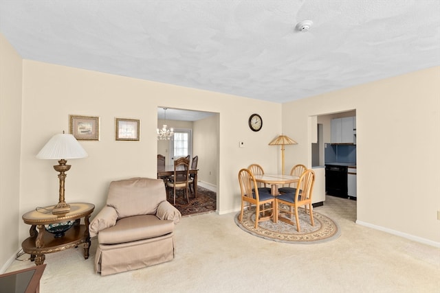 sitting room featuring a chandelier and light carpet