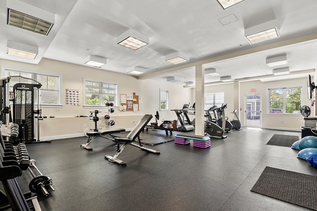 workout area featuring a wall unit AC and plenty of natural light