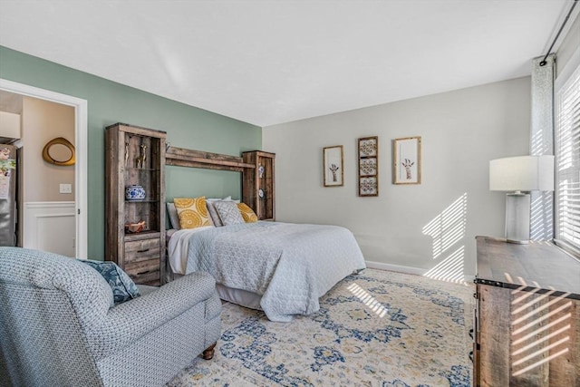 bedroom with multiple windows and wainscoting