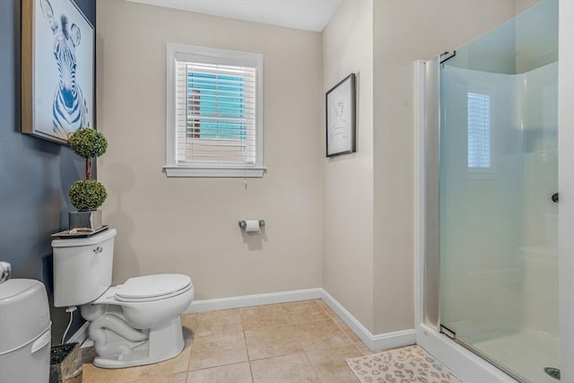 full bathroom with a shower stall, toilet, baseboards, and tile patterned floors