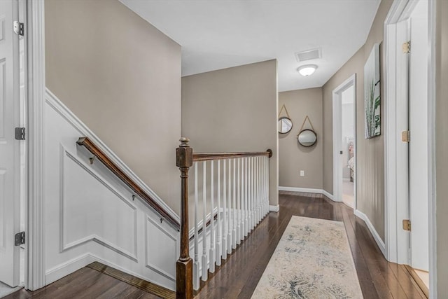 interior space featuring dark wood finished floors, visible vents, and baseboards