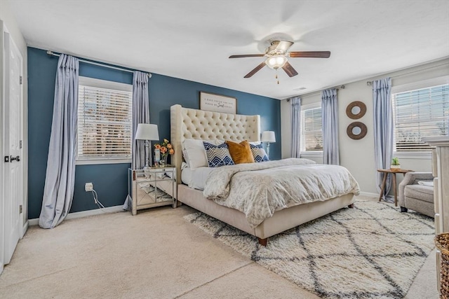 carpeted bedroom with a ceiling fan and baseboards