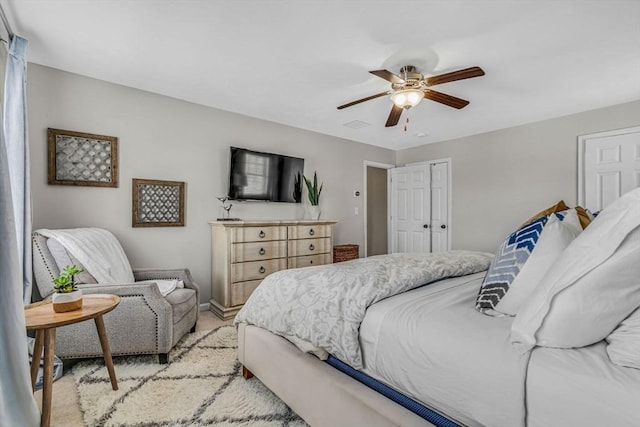 bedroom featuring baseboards, light carpet, and ceiling fan