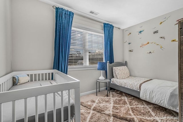 bedroom with visible vents, baseboards, and carpet flooring