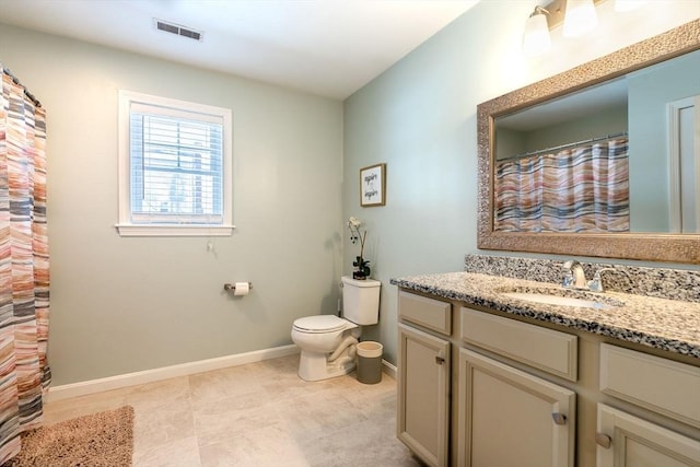 bathroom with visible vents, toilet, vanity, and baseboards