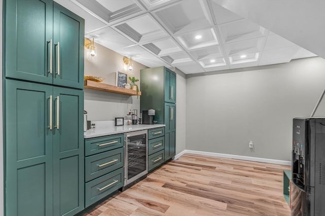 kitchen featuring beverage cooler, green cabinetry, light countertops, light wood-style floors, and open shelves